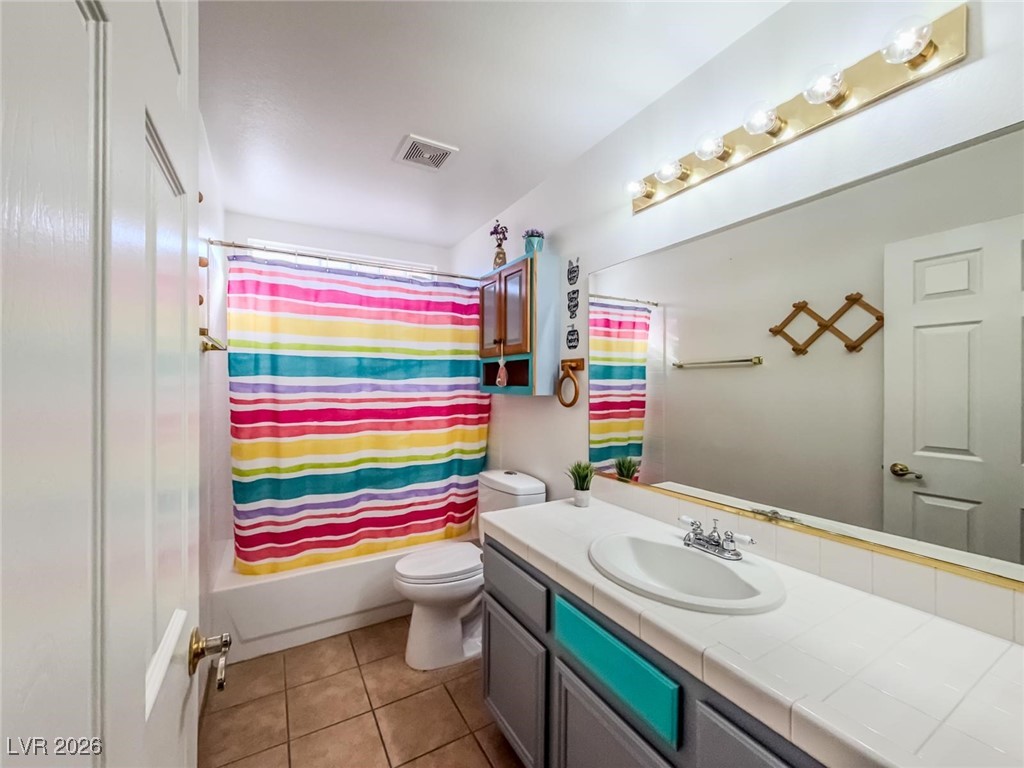 5308 Scoreboard Street Las Vegas, NV 89130 - Photo 15 of 32 Full bath with vanity, shower / bathtub combination with curtain, and light tile patterned floors