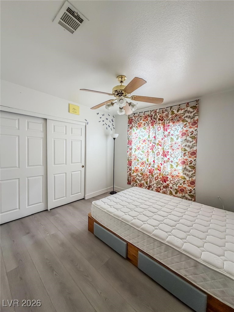 5308 Scoreboard Street Las Vegas, NV 89130 - Photo 16 of 32 Bedroom featuring wood finished floors, a closet, and ceiling fan