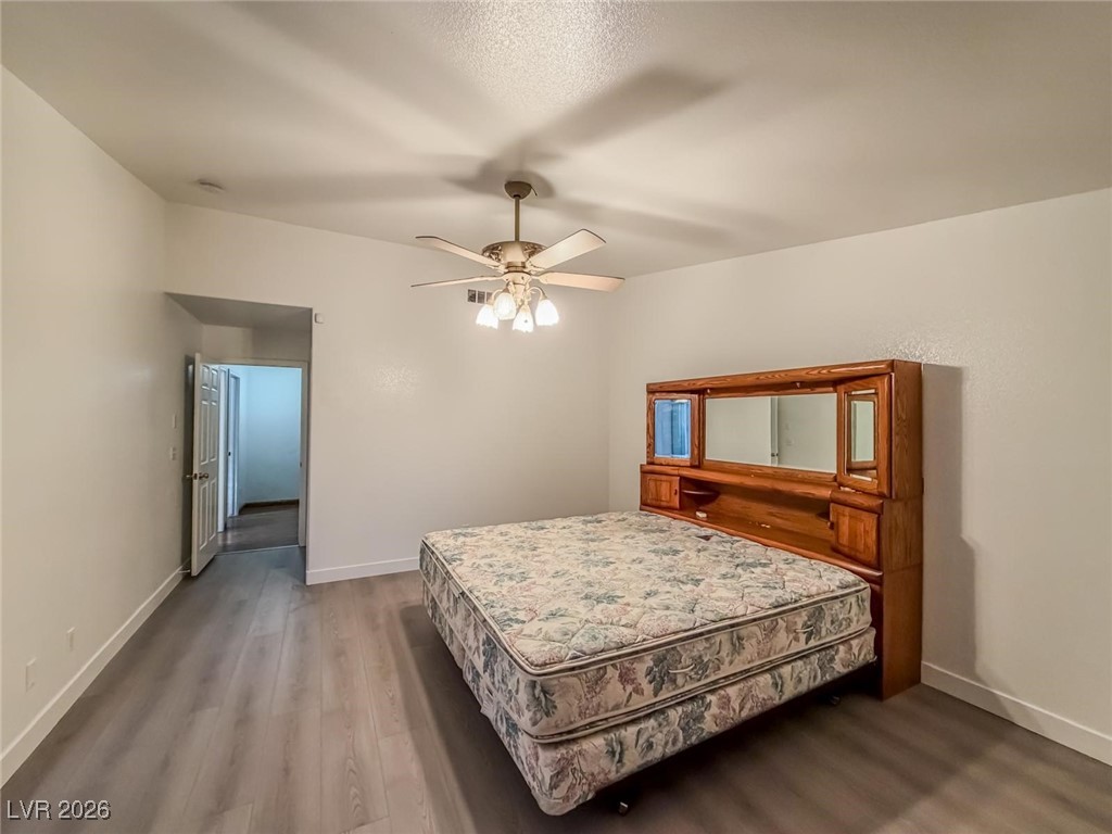 5308 Scoreboard Street Las Vegas, NV 89130 - Photo 20 of 32 Bedroom with dark wood-type flooring and ceiling fan