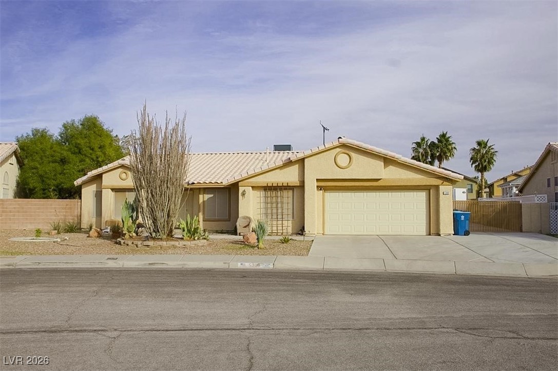 5308 Scoreboard Street Las Vegas, NV 89130 - Photo 25 of 32 View of front of house featuring concrete driveway, stucco siding, and an attached garage