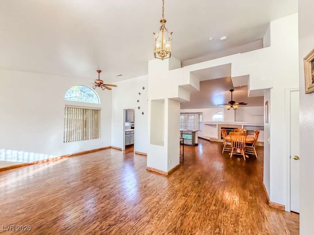 5308 Scoreboard Street Las Vegas, NV 89130 - Photo 26 of 32 Living room featuring ceiling fan, a high ceiling, and dark wood-type flooring