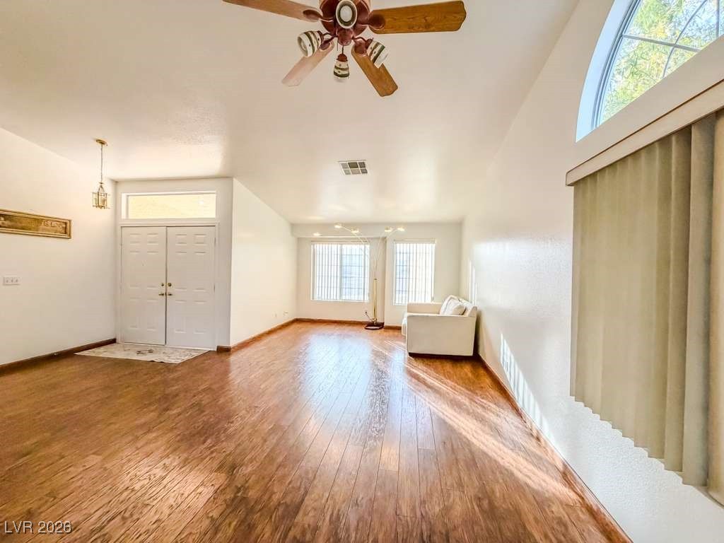 5308 Scoreboard Street Las Vegas, NV 89130 - Photo 27 of 32 Unfurnished living room with hardwood / wood-style floors, ceiling fan, and lofted ceiling