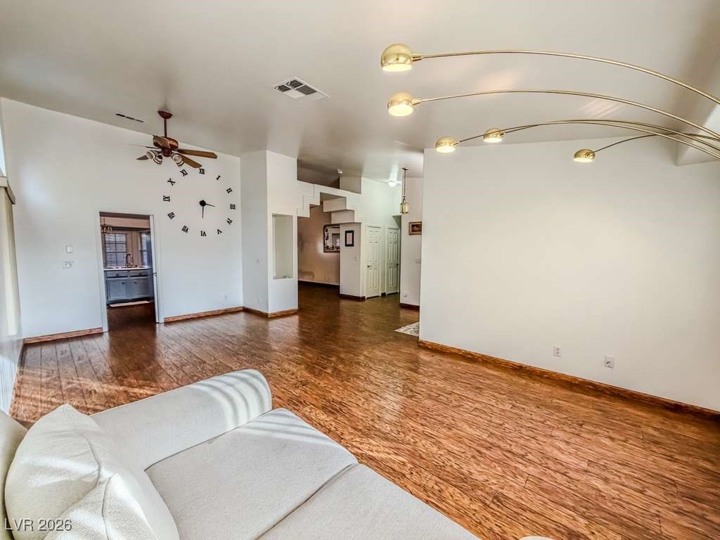 5308 Scoreboard Street Las Vegas, NV 89130 - Photo 28 of 32 Unfurnished living room featuring dark wood finished floors and ceiling fan