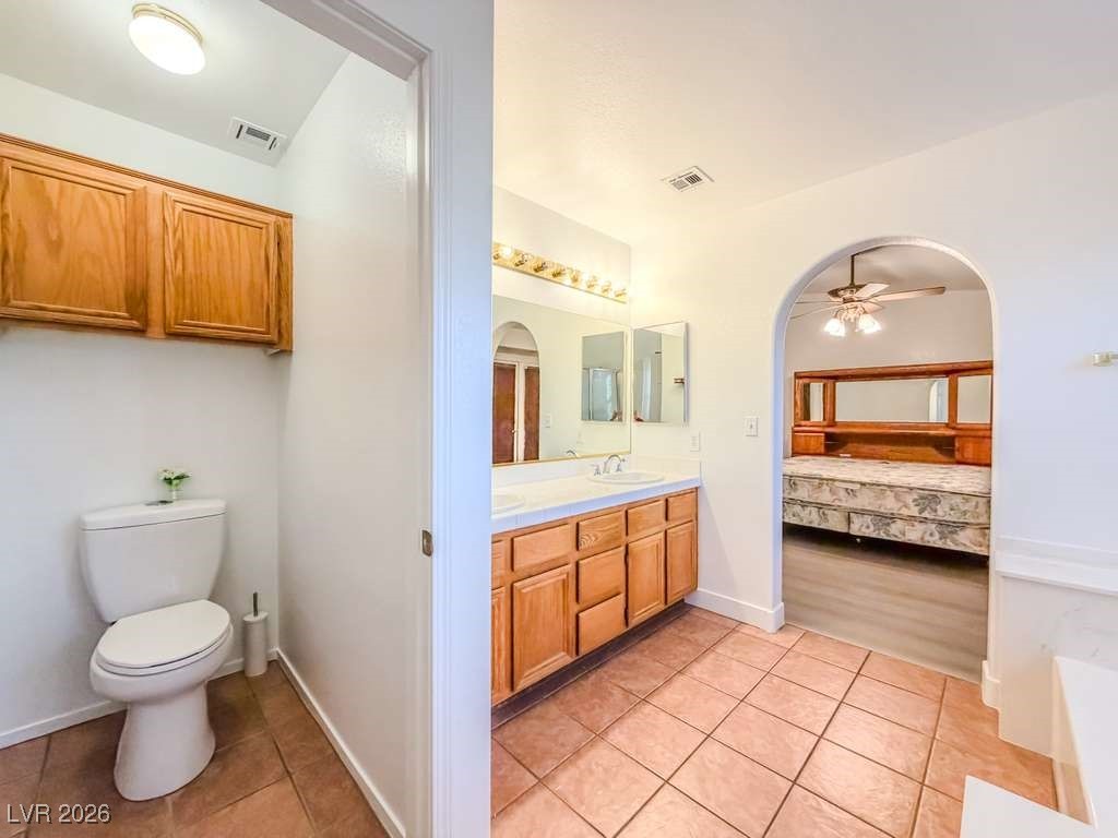 5308 Scoreboard Street Las Vegas, NV 89130 - Photo 29 of 32 Full bath with light tile patterned floors, ensuite bath, double vanity, and ceiling fan