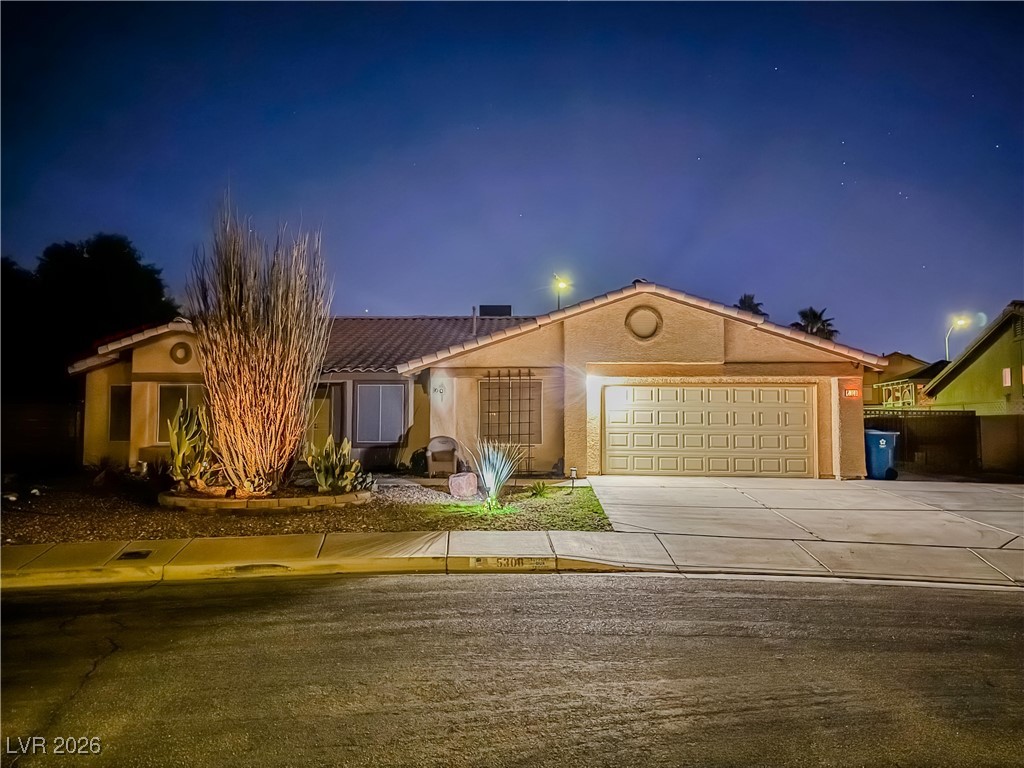 5308 Scoreboard Street Las Vegas, NV 89130 - Photo 3 of 32 View of front facade with concrete driveway, a garage, and stucco siding