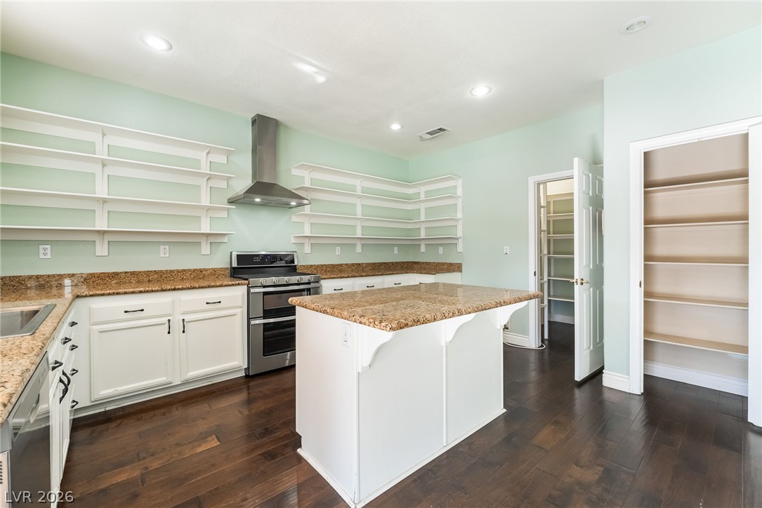261 Timber Hollow Street Henderson, NV 89012 - Photo 15 of 51 Culinary creations come to life in this kitchen, complete with a generous island and ample pantry storage.