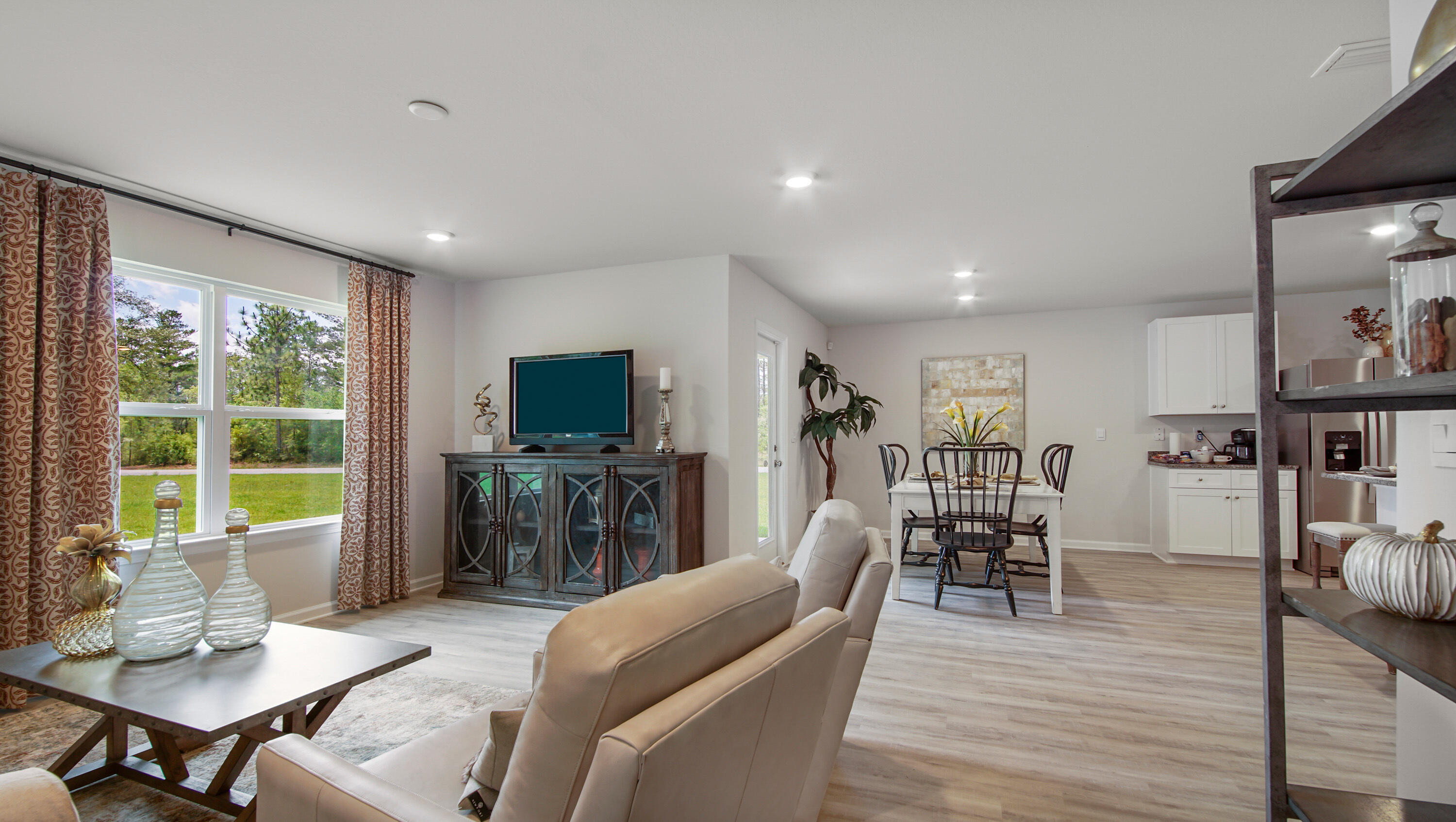 203 Eunola Lane Freeport, FL 32439 - Photo 12 of 38 a living room with furniture a flat screen tv and a large window