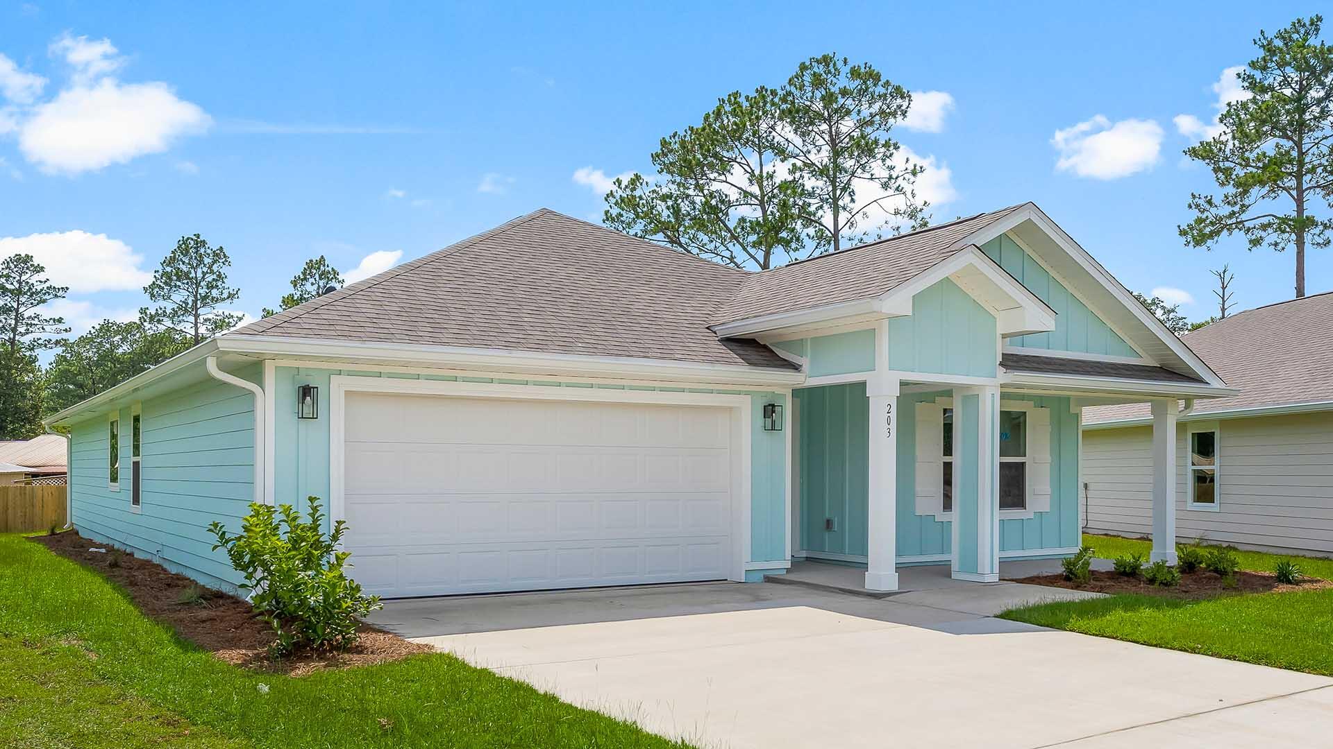 203 Eunola Lane Freeport, FL 32439 - Photo 36 of 38 a front view of a house with a yard and garage