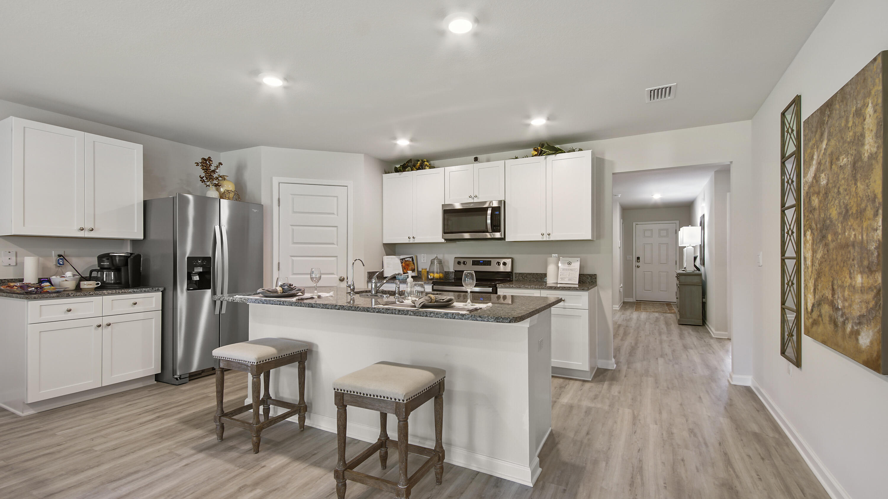 203 Eunola Lane Freeport, FL 32439 - Photo 7 of 38 a kitchen with white cabinets and stainless steel appliances