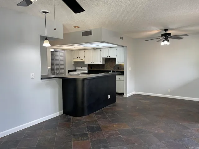 a kitchen with stainless steel appliances granite countertop a sink and a stove