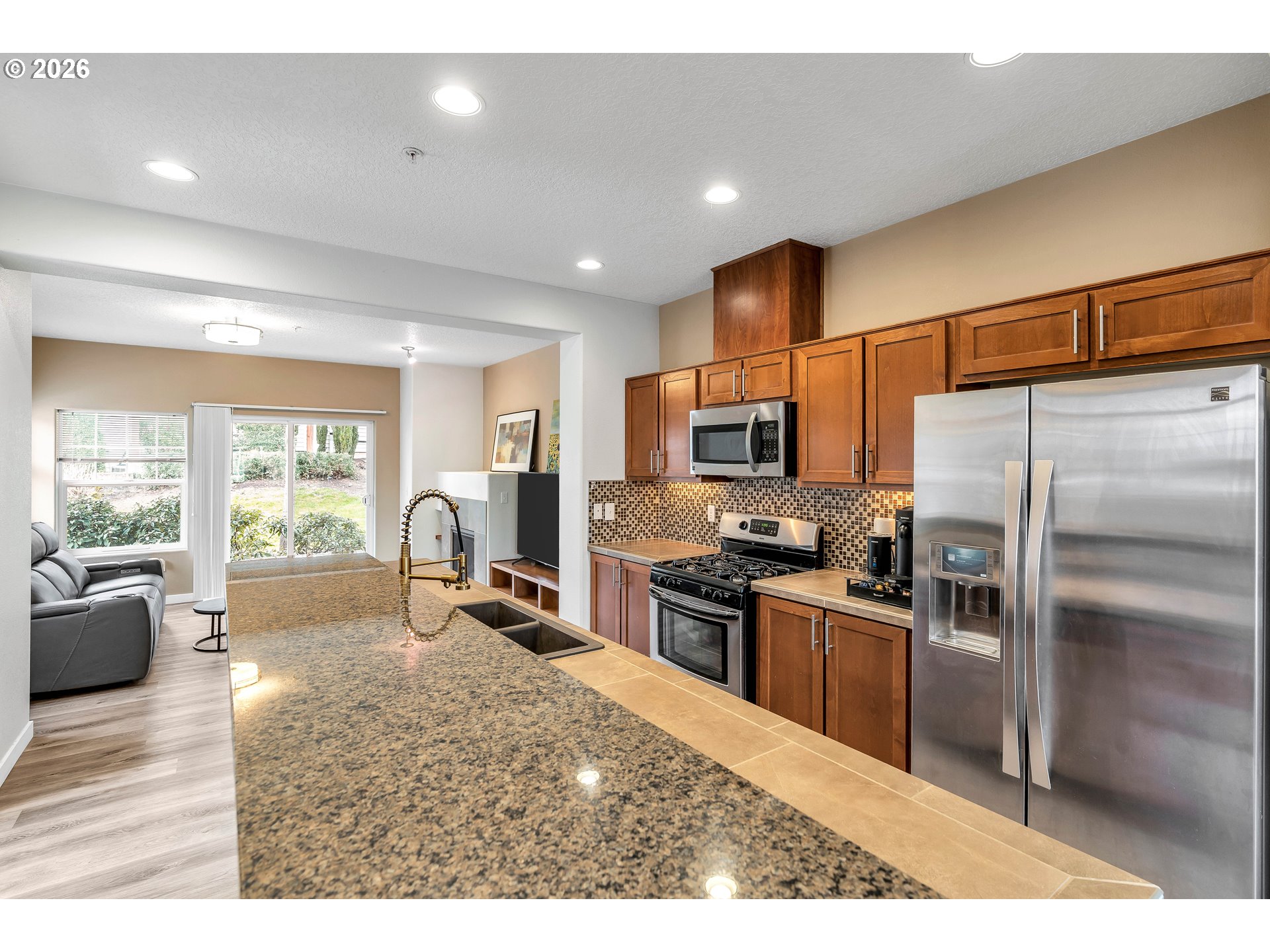 350 Northwest 116th Avenue, Unit 101 Portland, OR 97229 - Photo 12 of 38 a kitchen with granite countertop a refrigerator stove top oven and sink