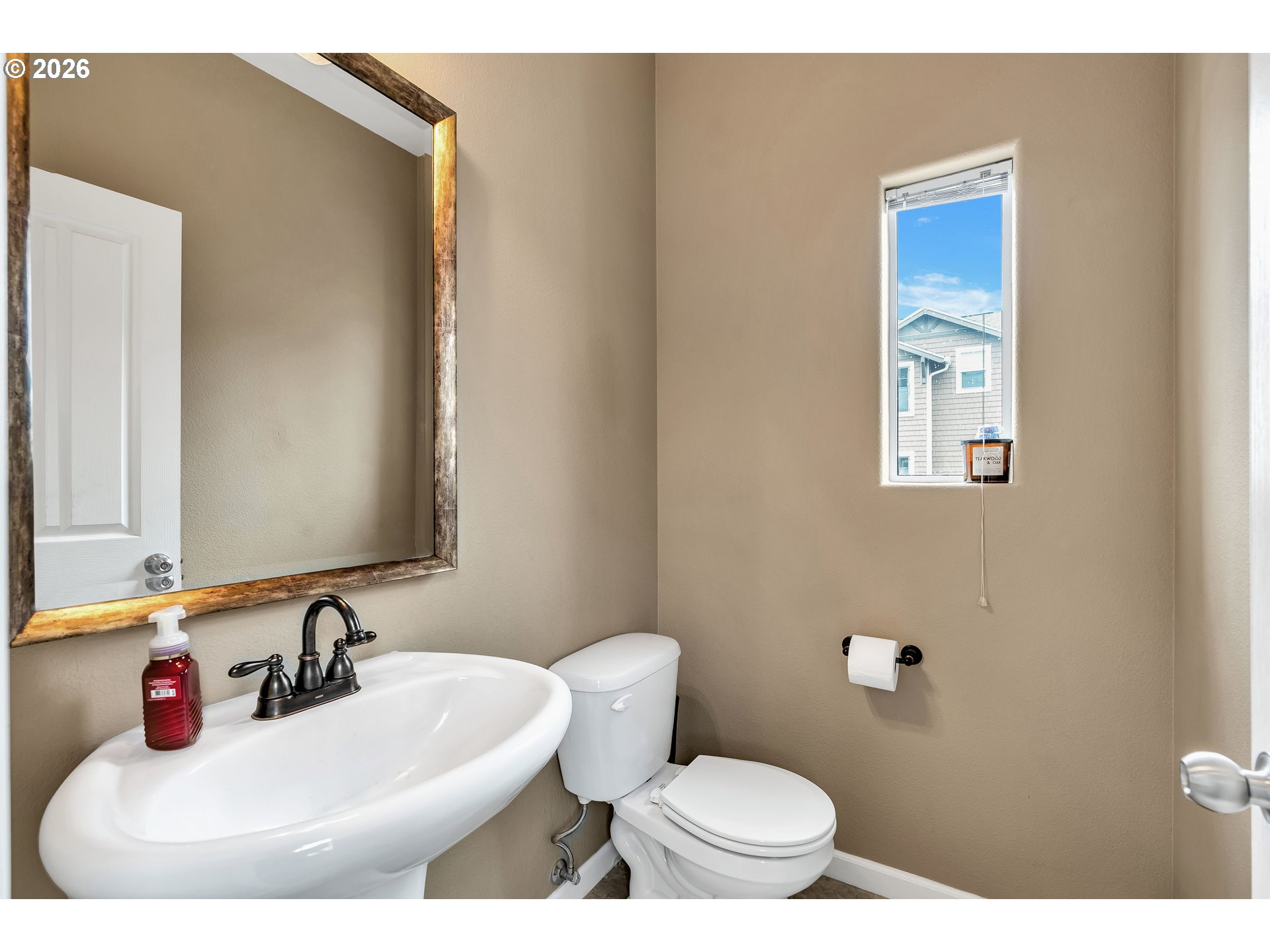 350 Northwest 116th Avenue, Unit 101 Portland, OR 97229 - Photo 16 of 38 a bathroom with a sink a toilet and mirror