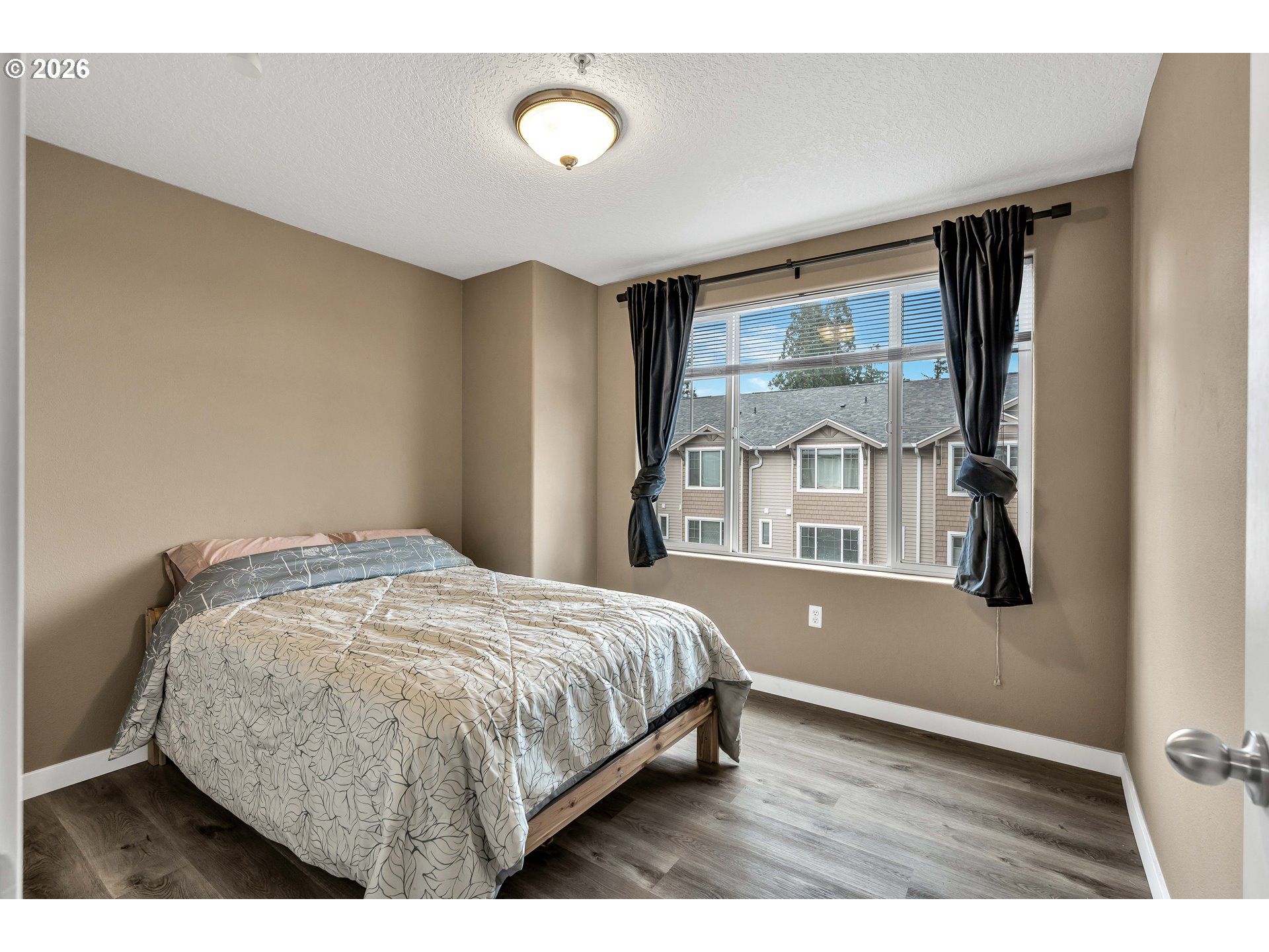 350 Northwest 116th Avenue, Unit 101 Portland, OR 97229 - Photo 17 of 38 a bedroom with a bed and window