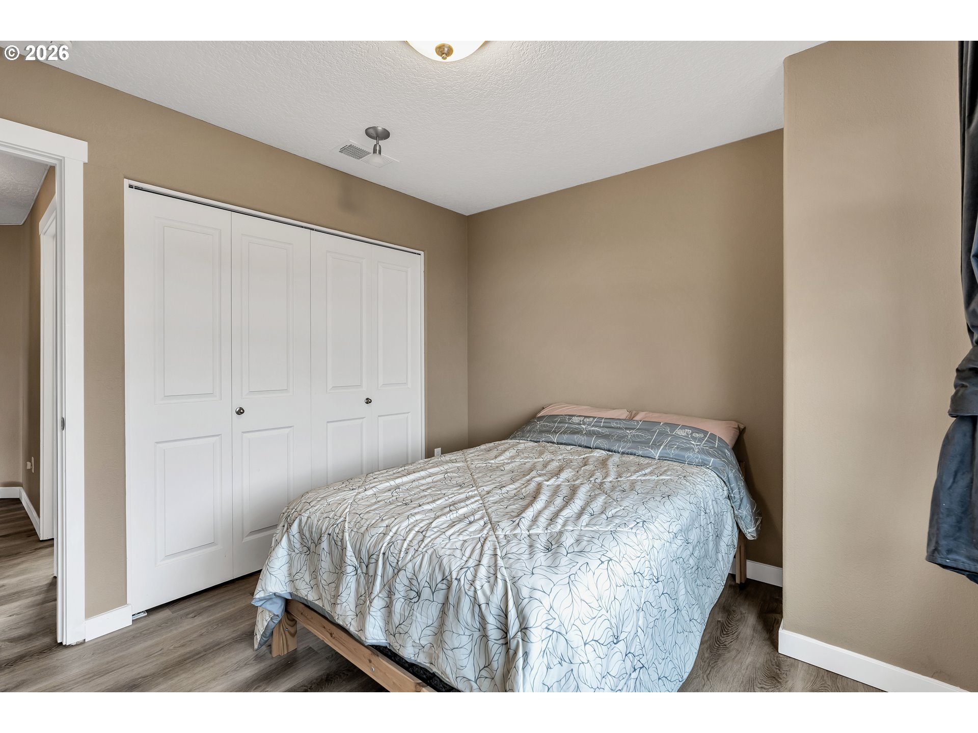 350 Northwest 116th Avenue, Unit 101 Portland, OR 97229 - Photo 18 of 38 a bedroom with a bed and a cabinets
