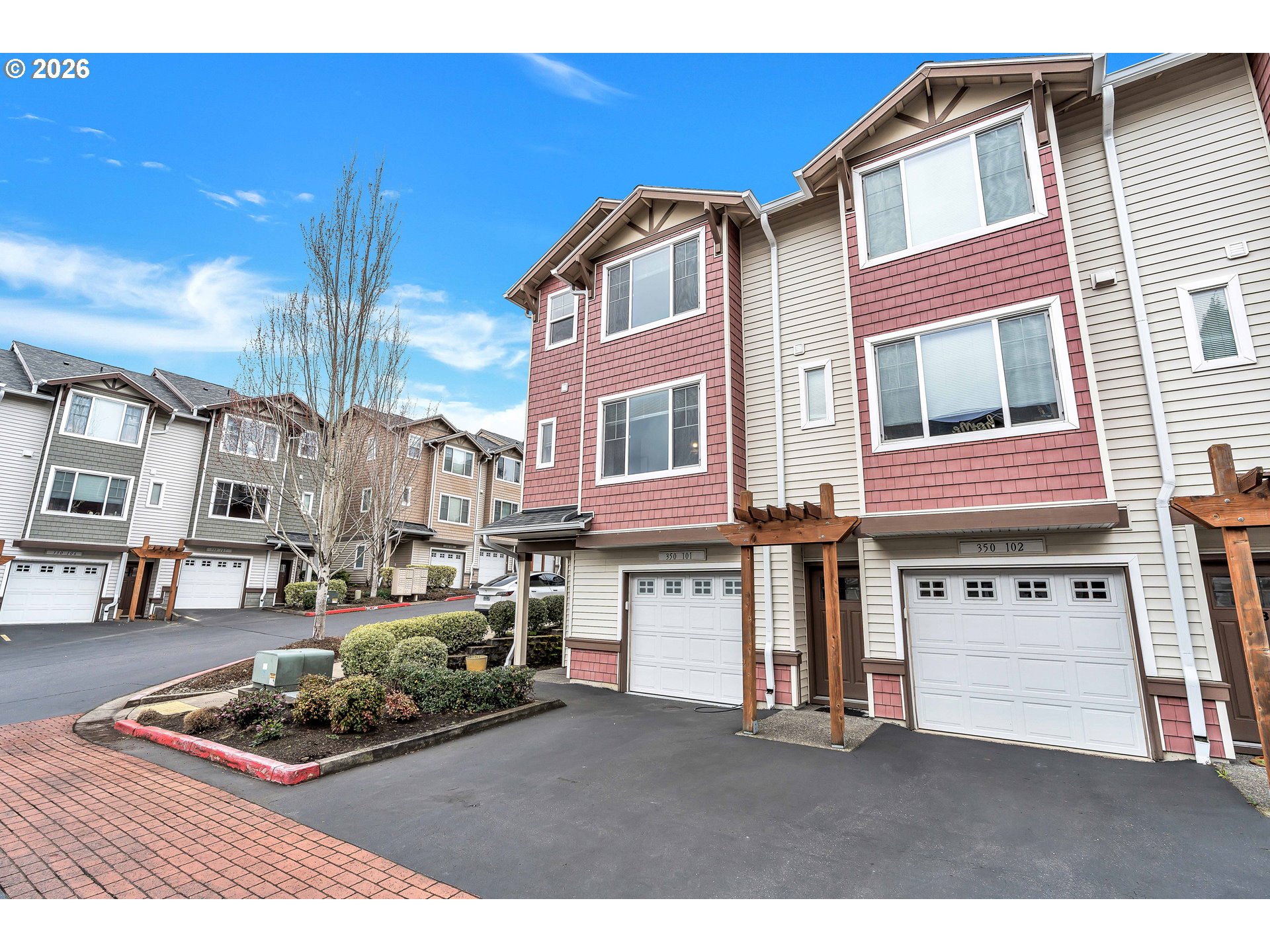 350 Northwest 116th Avenue, Unit 101 Portland, OR 97229 - Photo 2 of 38 a front view of a residential apartment building with a yard