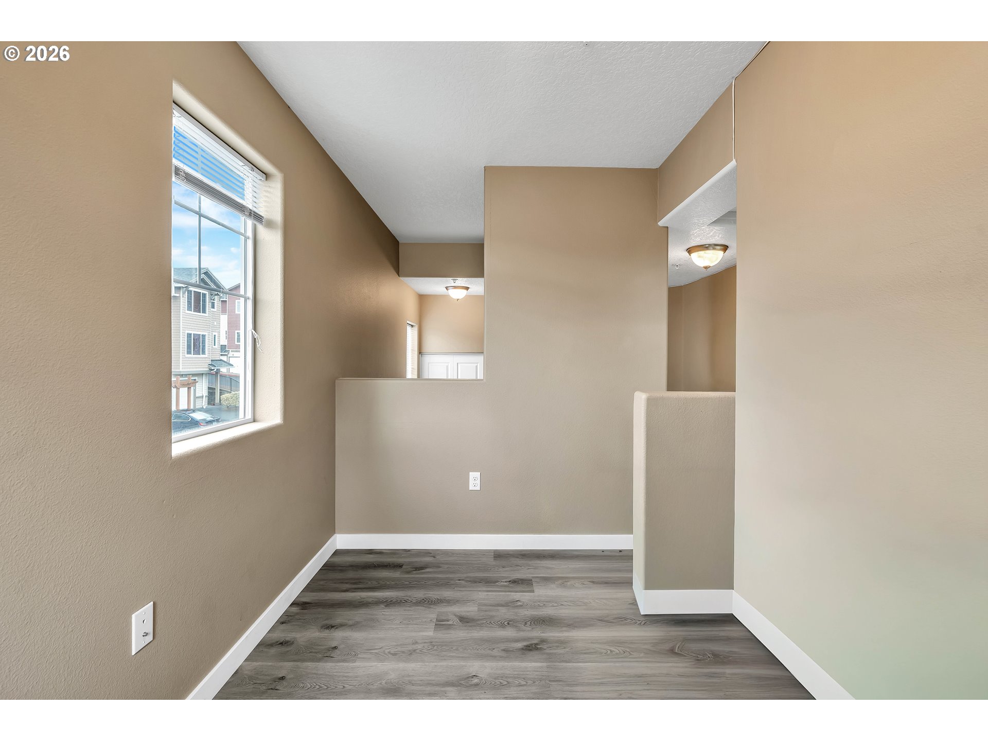 350 Northwest 116th Avenue, Unit 101 Portland, OR 97229 - Photo 22 of 38 a view of an empty room with window and wooden floor