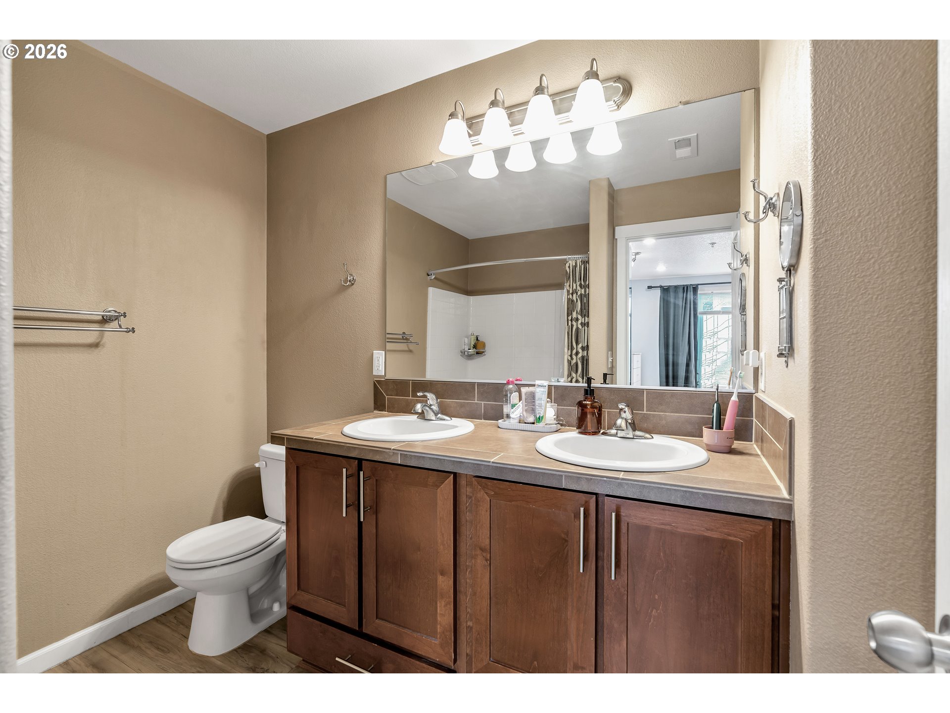 350 Northwest 116th Avenue, Unit 101 Portland, OR 97229 - Photo 26 of 38 a bathroom with a toilet a sink and a mirror