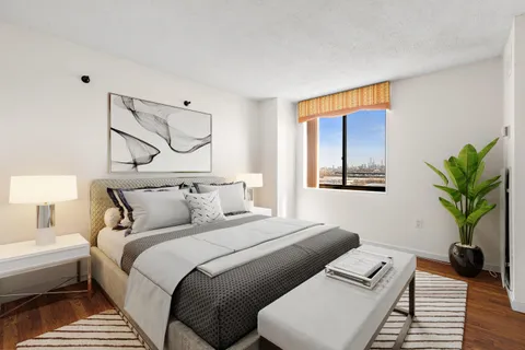 a bedroom with bed and a window