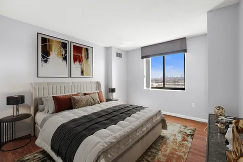 a bedroom with a bed and a painting on the wall