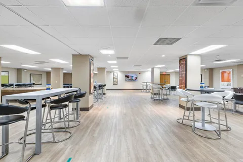 a view of a dining hall with furniture and wooden floor