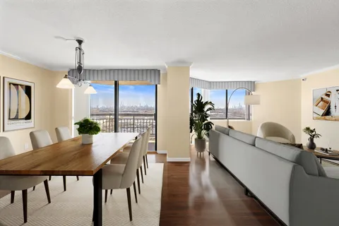 a living room with furniture dining table and a wooden floor