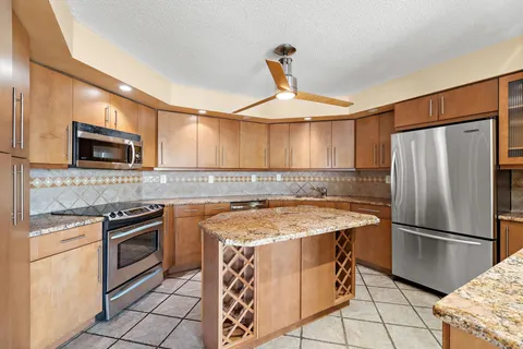 a kitchen with a stove a sink and a refrigerator