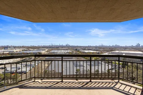 a view of a balcony with wooden floor and city view