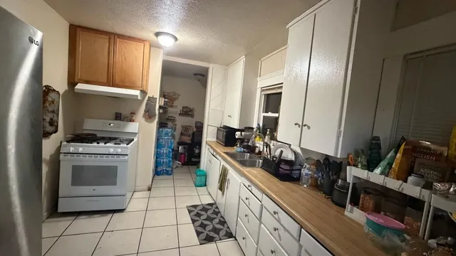 a kitchen with a sink stove and cabinets