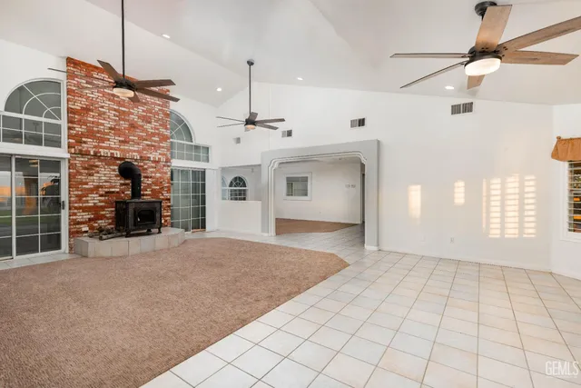 a large kitchen with stainless steel appliances granite countertop a stove a sink and a microwave