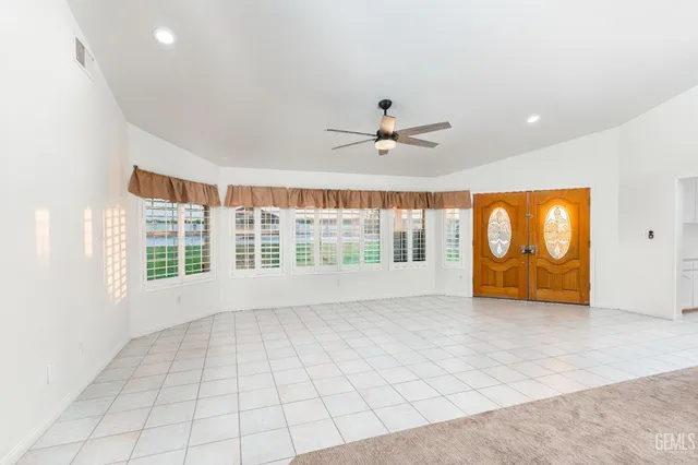 a kitchen with kitchen island granite countertop a stove sink and cabinets