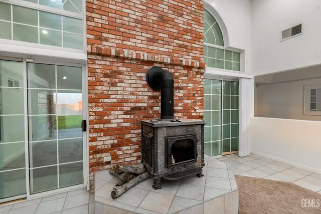 a kitchen with granite countertop white cabinets stainless steel appliances a sink and a window