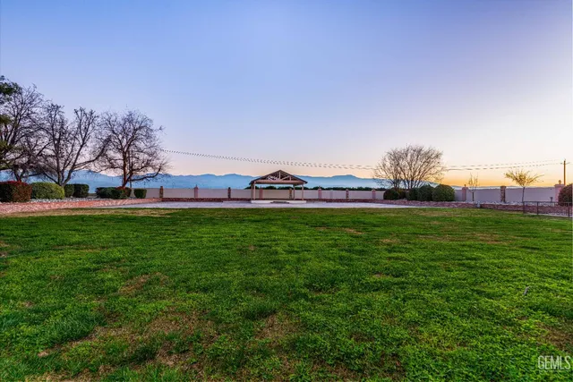 an aerial view of residential houses with outdoor space and ocean view