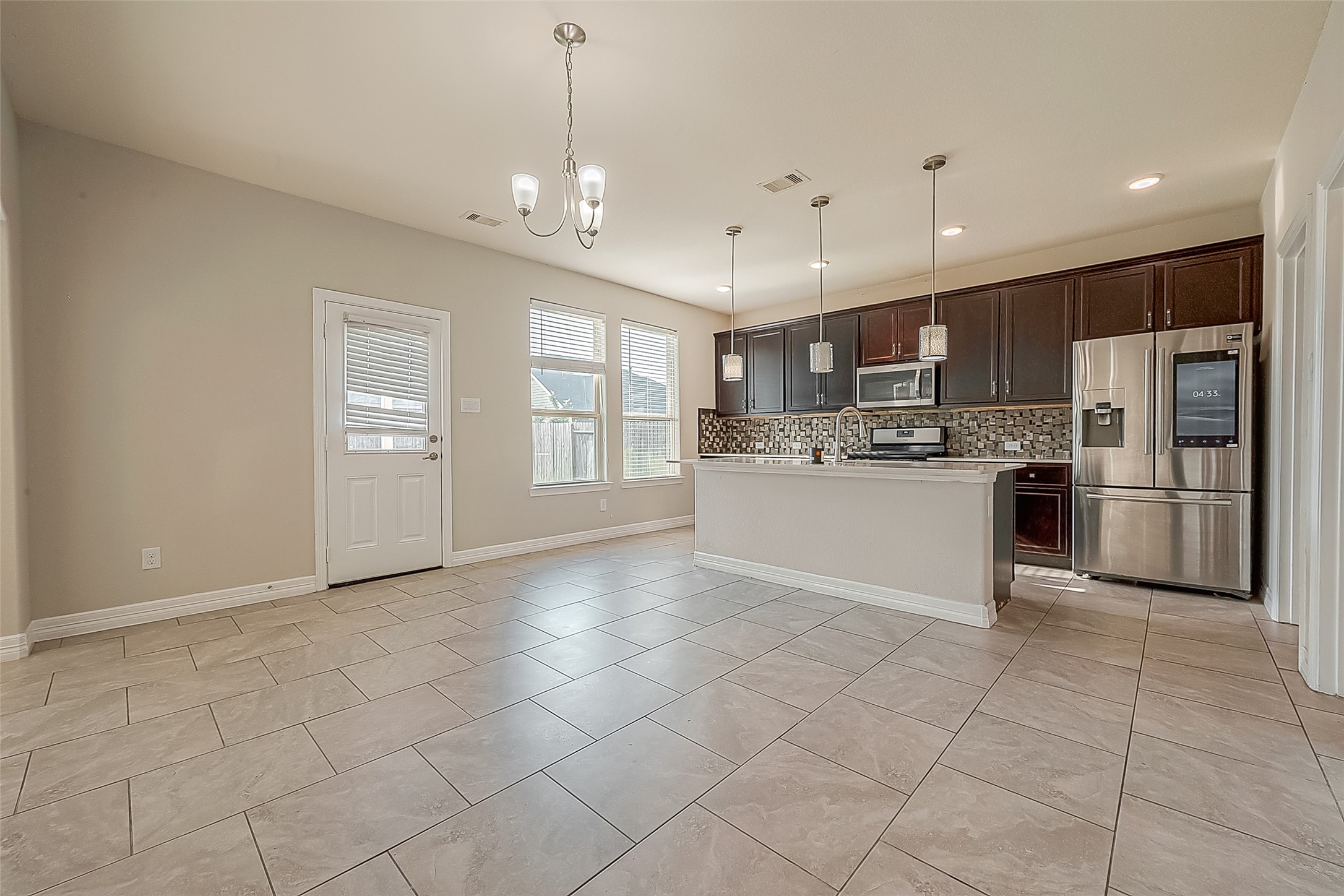 223 Sintra Lk Way Rosenberg, TX 77469 - Photo 6 of 43 a kitchen with stainless steel appliances granite countertop a refrigerator and a stove top oven