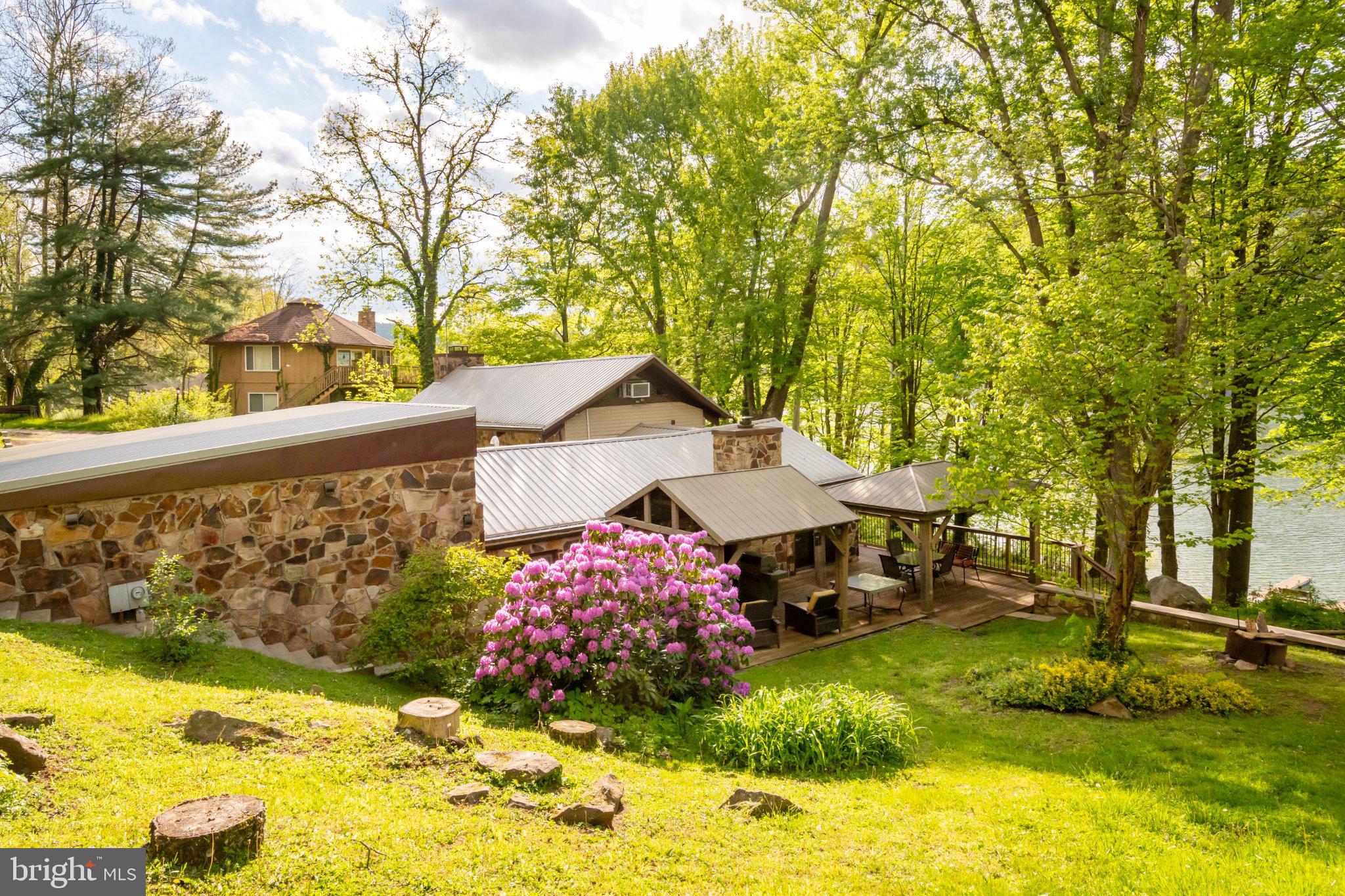 750 Lake Side Road Addison, PA 15411 - Photo 7 of 51 Serene riverside retreat in lush greenery.