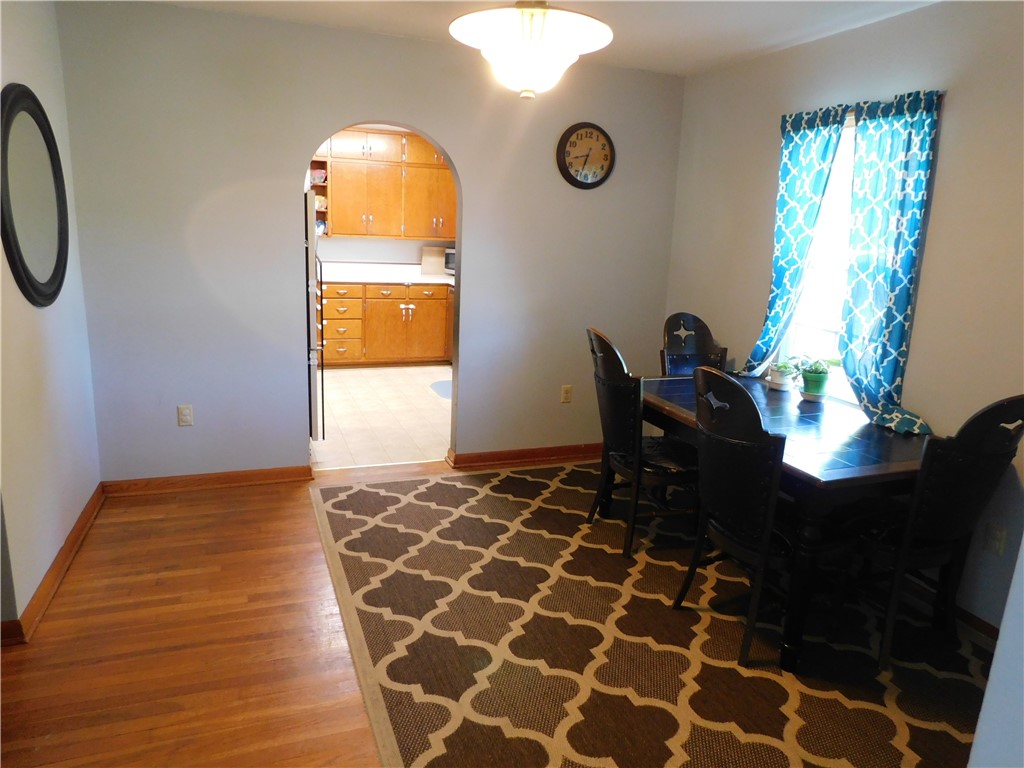 1301 East Main Street Casey, IL 62420 - Photo 5 of 14 a living room with a black white checkered floor with a gaming machine and a potted plant
