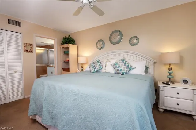 a spacious bedroom with a bed and a dresser