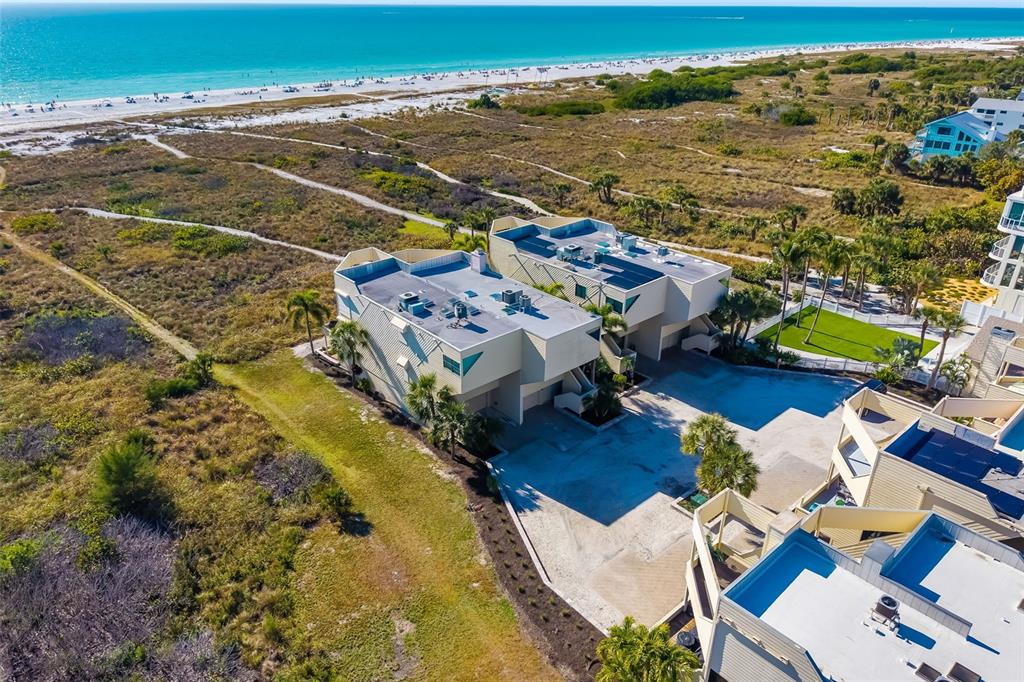 an aerial view of residential houses with outdoor space