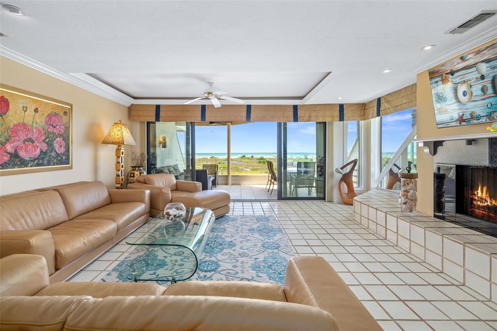 546A Beach Road, Unit A544 Sarasota, FL 34242 - Photo 11 of 59 a living room with furniture large window and a fireplace
