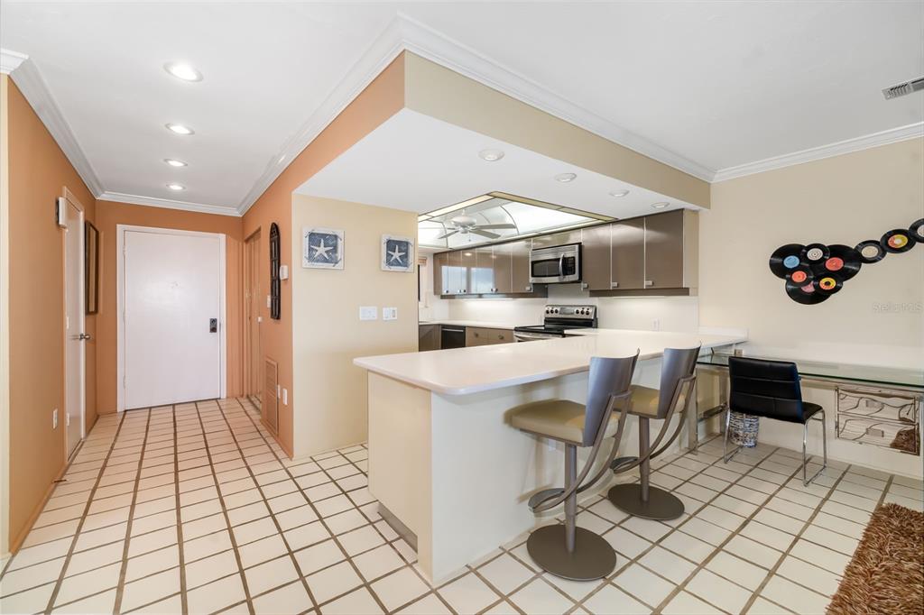 546A Beach Road, Unit A544 Sarasota, FL 34242 - Photo 15 of 59 a kitchen with stainless steel appliances kitchen island granite countertop a sink and a refrigerator