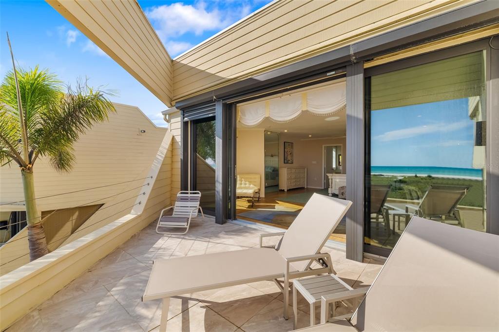 546A Beach Road, Unit A544 Sarasota, FL 34242 - Photo 29 of 59 a view of a patio with couches table and chairs and potted plants