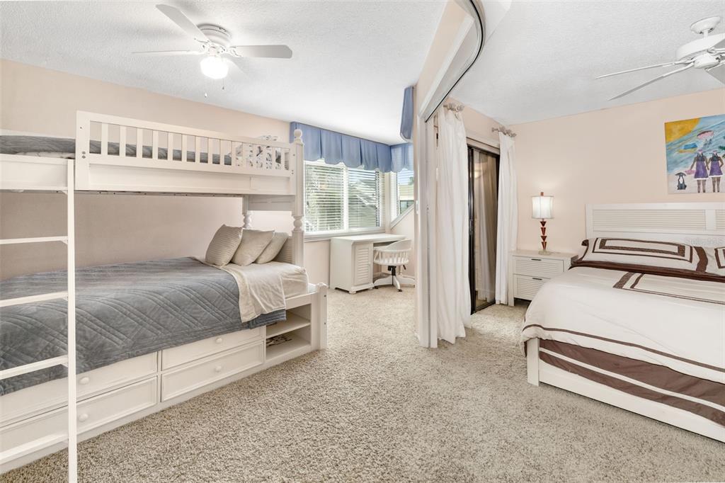 546A Beach Road, Unit A544 Sarasota, FL 34242 - Photo 33 of 59 a bedroom with a bed and a chandelier