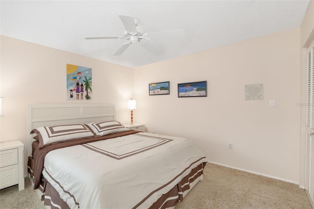 546A Beach Road, Unit A544 Sarasota, FL 34242 - Photo 34 of 59 a bedroom with a bed and a painting on the wall