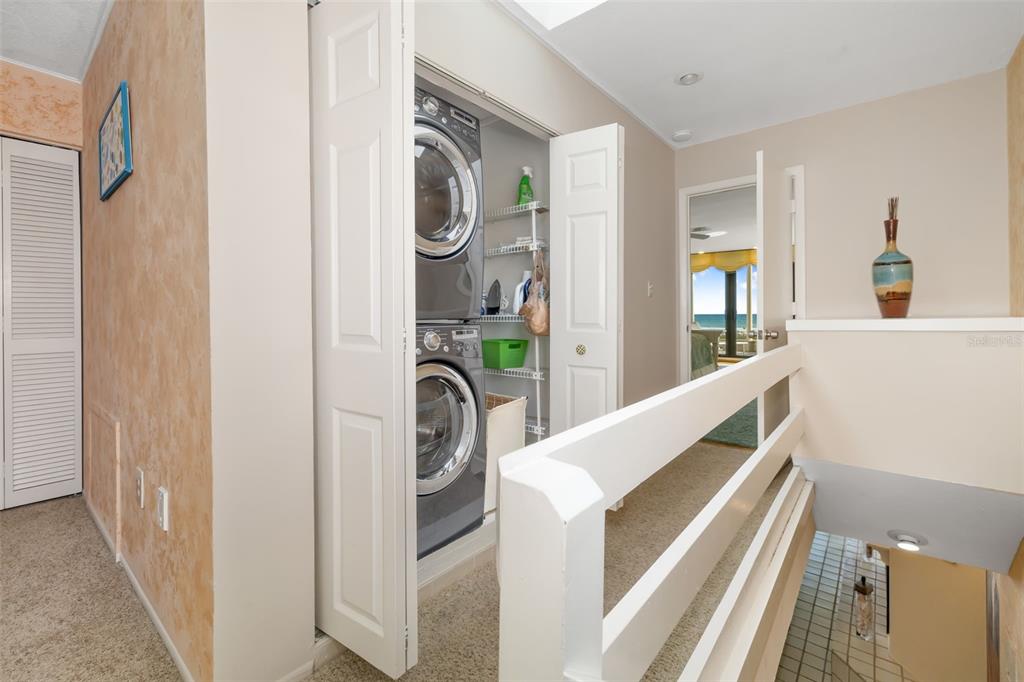 546A Beach Road, Unit A544 Sarasota, FL 34242 - Photo 36 of 59 a view of a hallway with washer and dryer