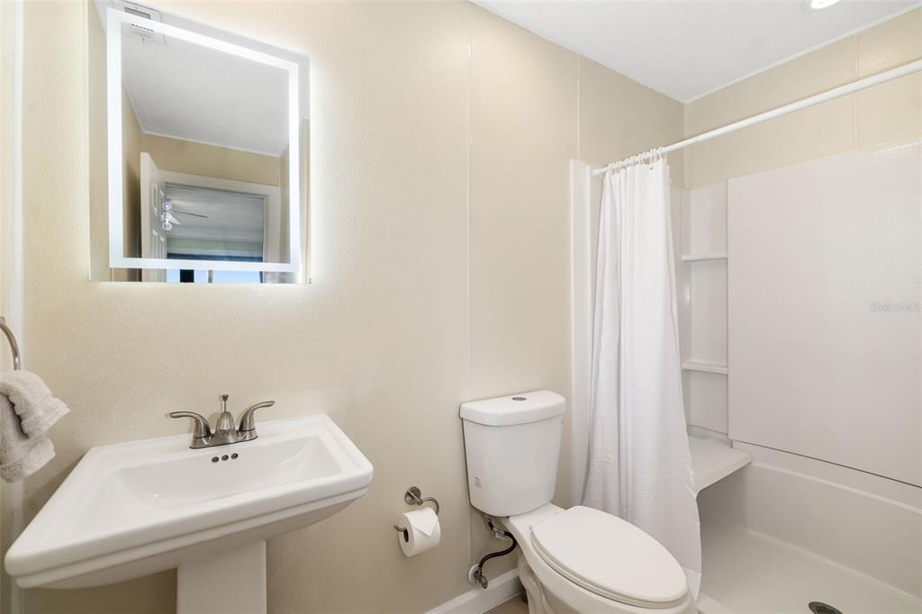 546A Beach Road, Unit A544 Sarasota, FL 34242 - Photo 38 of 59 a bathroom with a toilet a sink and mirror