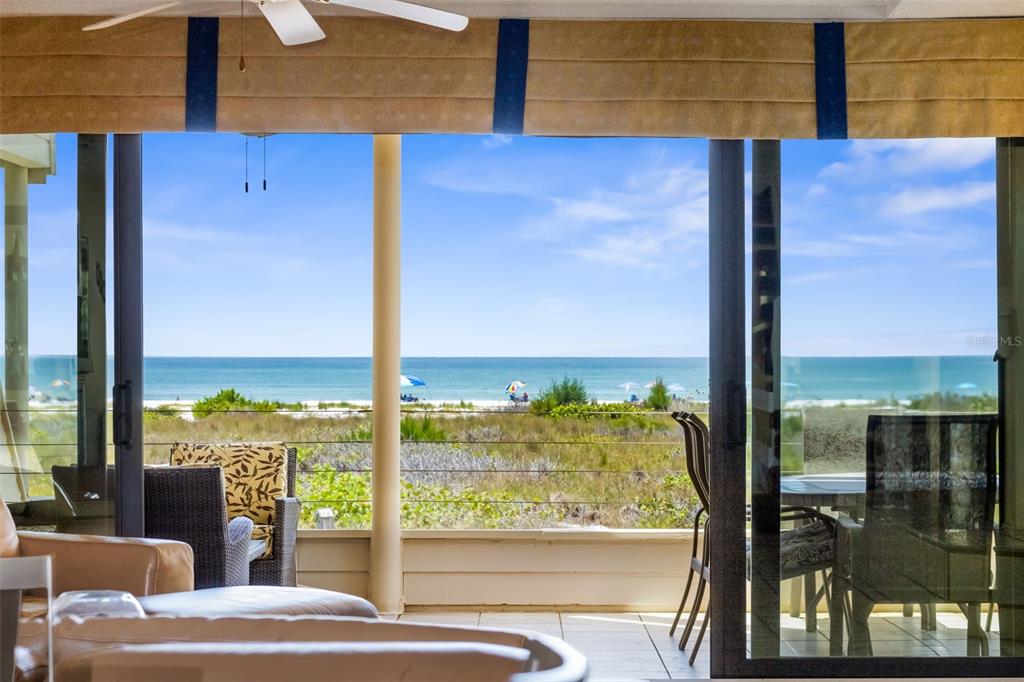 546A Beach Road, Unit A544 Sarasota, FL 34242 - Photo 8 of 59 a view of a living room with a floor to ceiling window and an outdoor kitchen