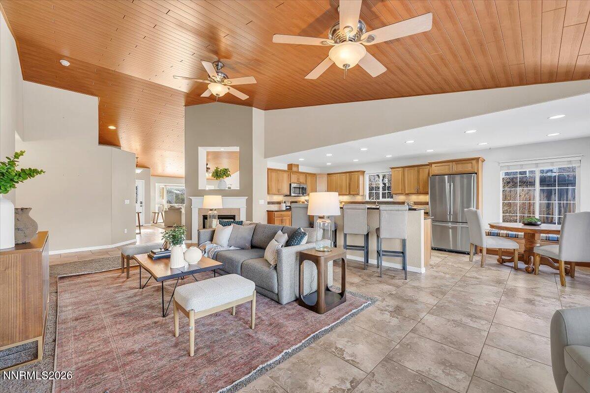 65 Rook Court Sparks, NV 89441 - Photo 13 of 41 a living room with furniture a dining table and chairs with floor to ceiling window