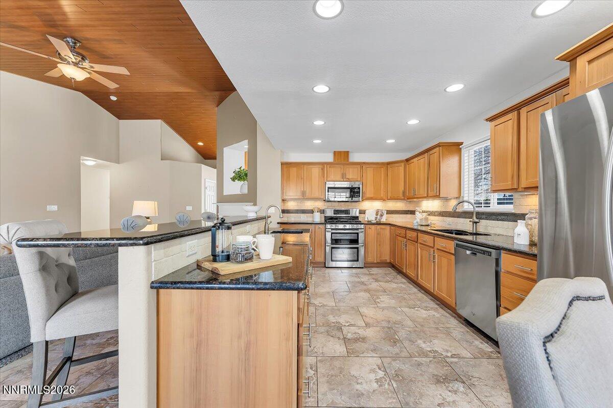 65 Rook Court Sparks, NV 89441 - Photo 17 of 41 a kitchen with stainless steel appliances granite countertop a refrigerator sink and cabinets