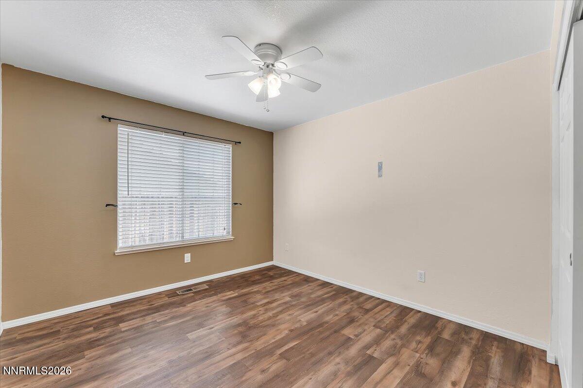 65 Rook Court Sparks, NV 89441 - Photo 24 of 41 an empty room with a chandelier fan and windows