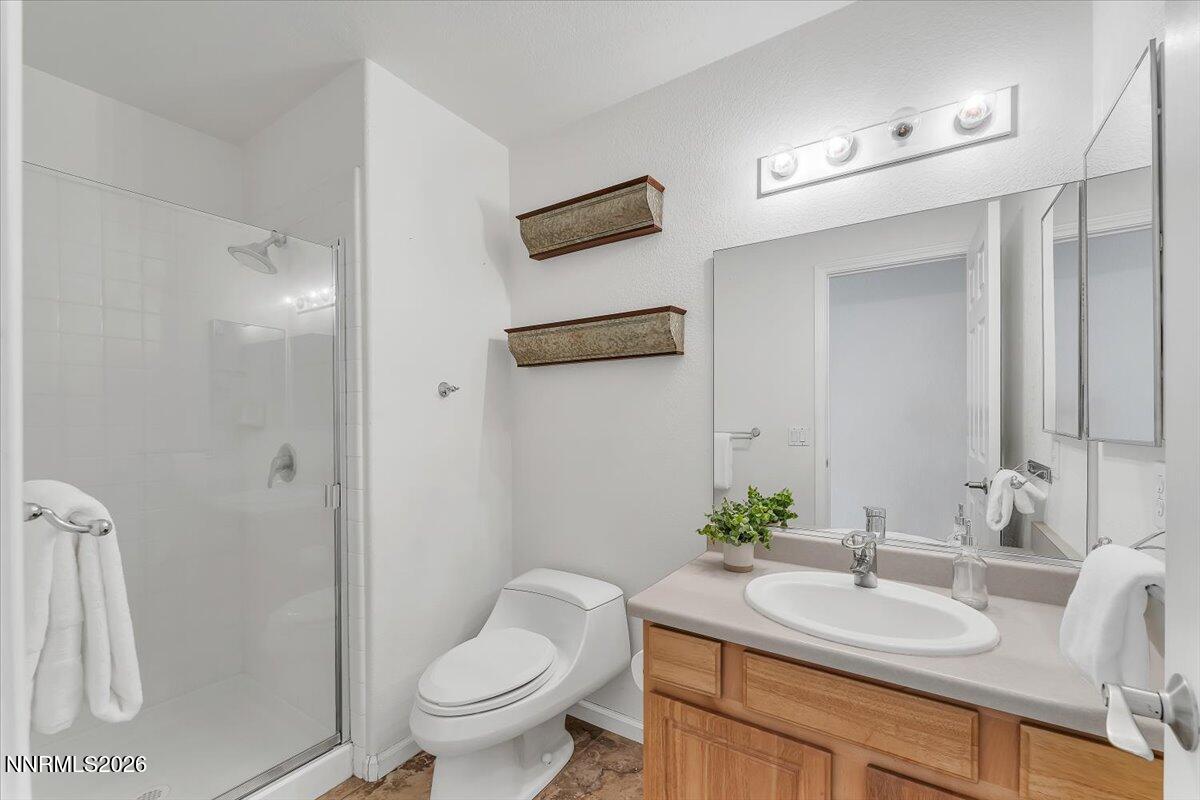 65 Rook Court Sparks, NV 89441 - Photo 28 of 41 a bathroom with a granite countertop sink a toilet and a mirror