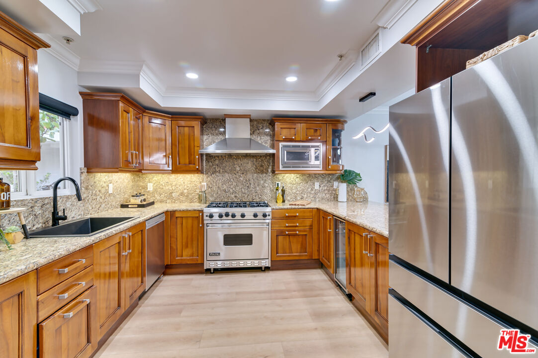 1878 Greenfield Avenue, Unit 104 Los Angeles, CA 90025 - Photo 11 of 35 a kitchen with stainless steel appliances granite countertop a sink stove and refrigerator
